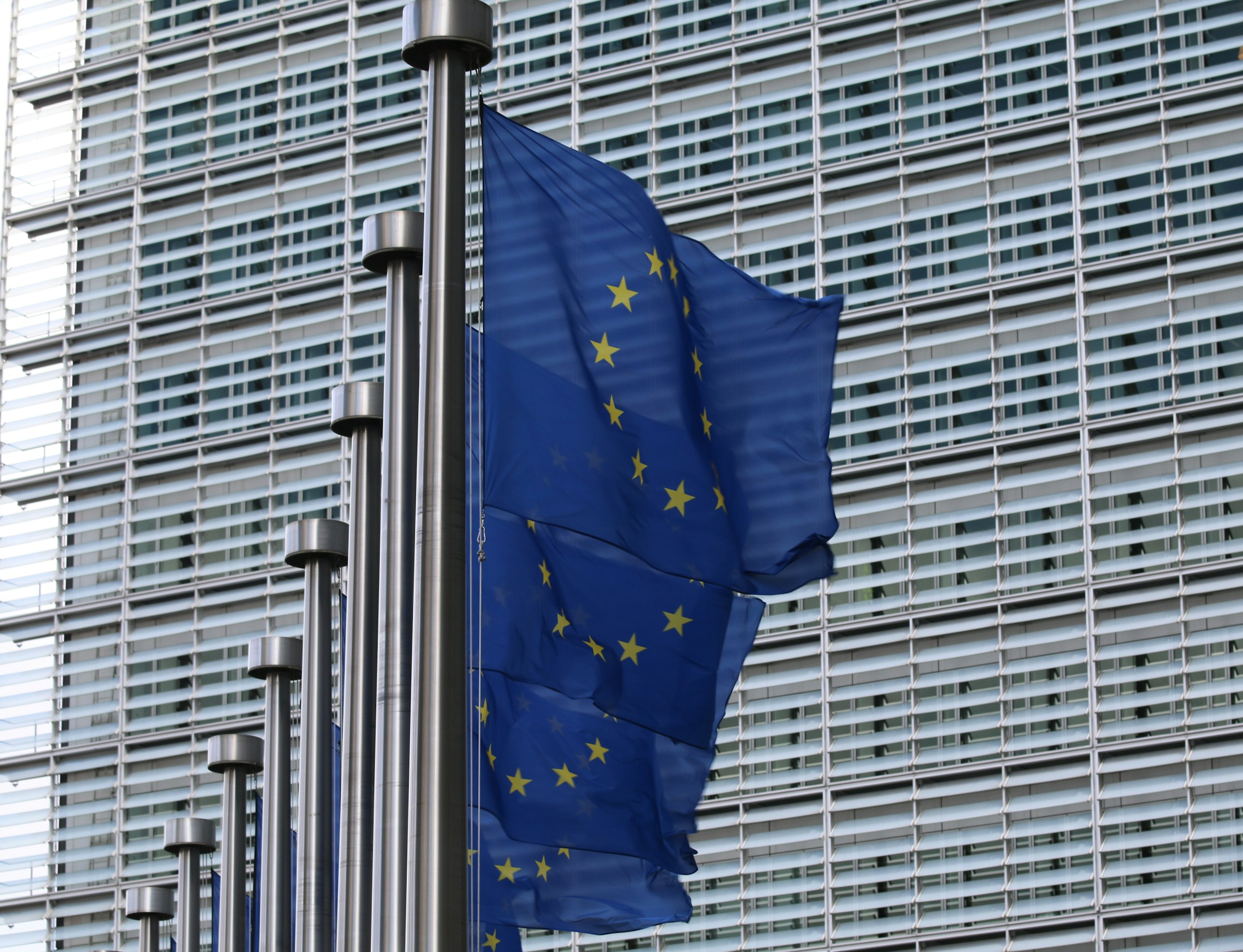 Photo of EU flags as EU-funded initiative CERTAIN aims to drive ethical AI compliance in Europe amid increasing regulations like the EU AI Act.